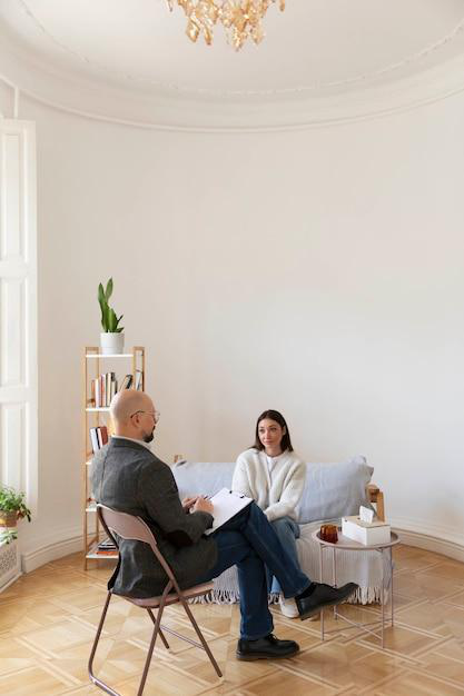 A female patient sits across from a therapist.