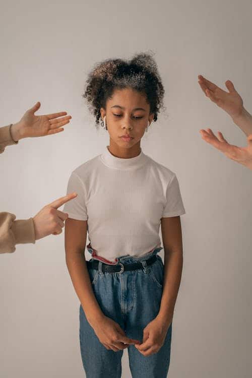 Silent teenage girl sitting while parents try to talk to her