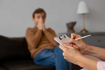 Man receiving psychiatric evaluation for impulse control issues during a therapy session