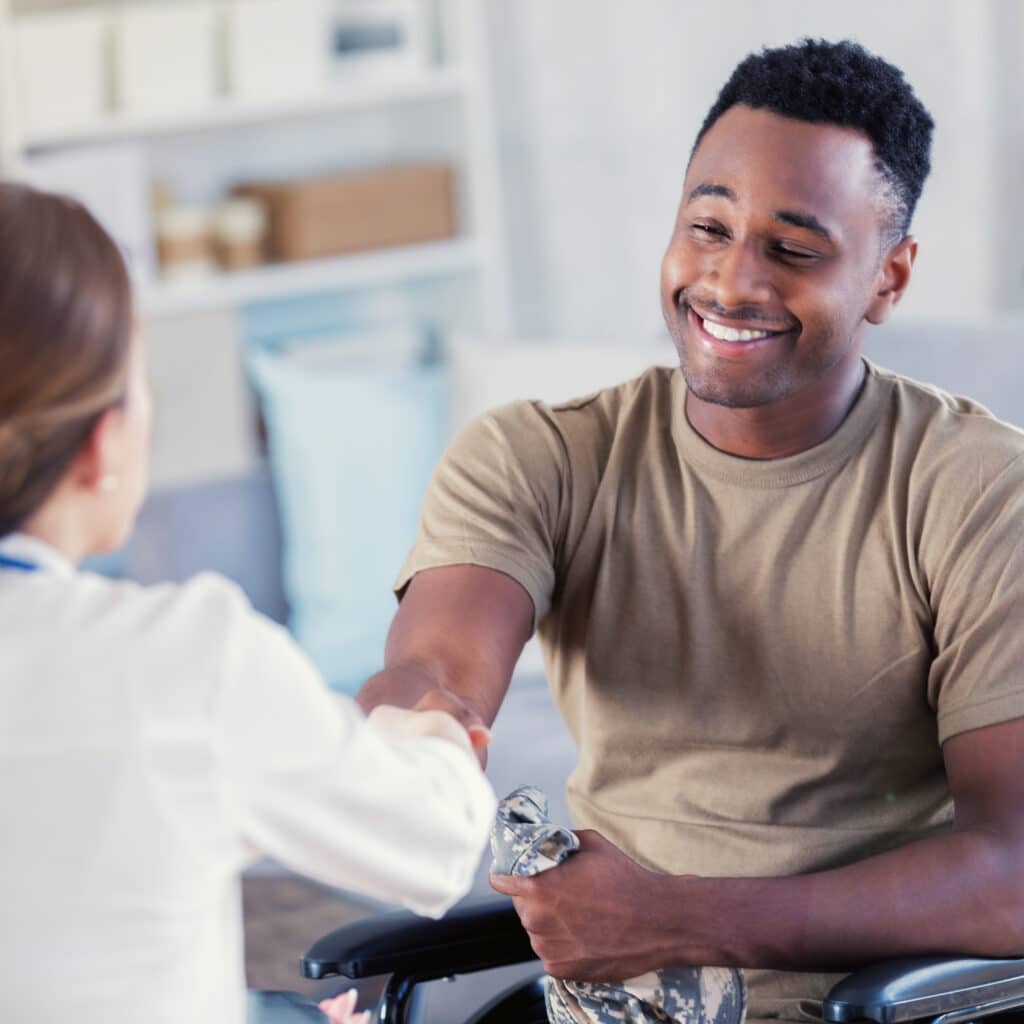 Military veteran shakes hands with therapist