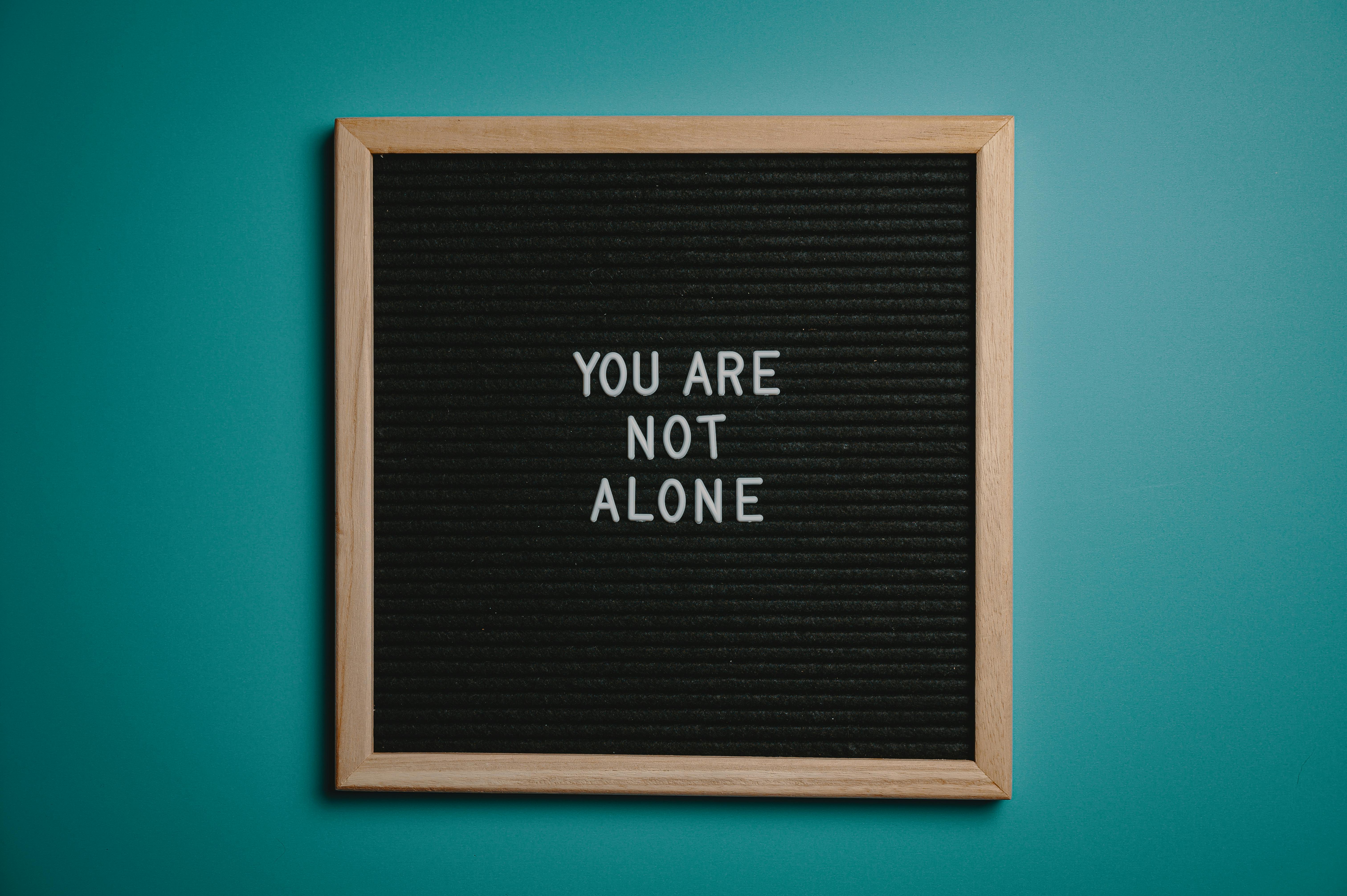 message board displaying "You Are Not Alone" with a heart symbol